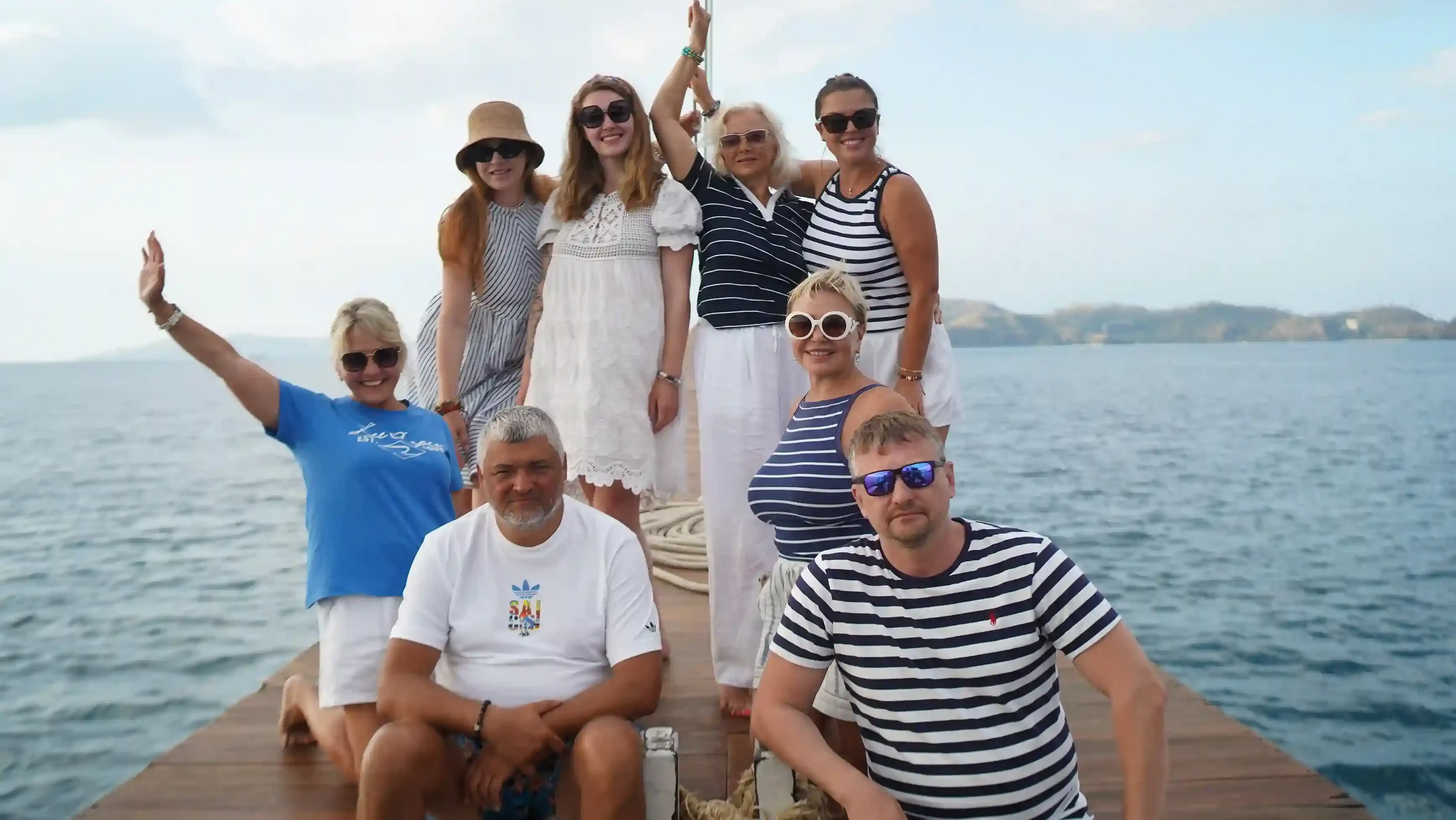 A multi-generation group posing on the bow