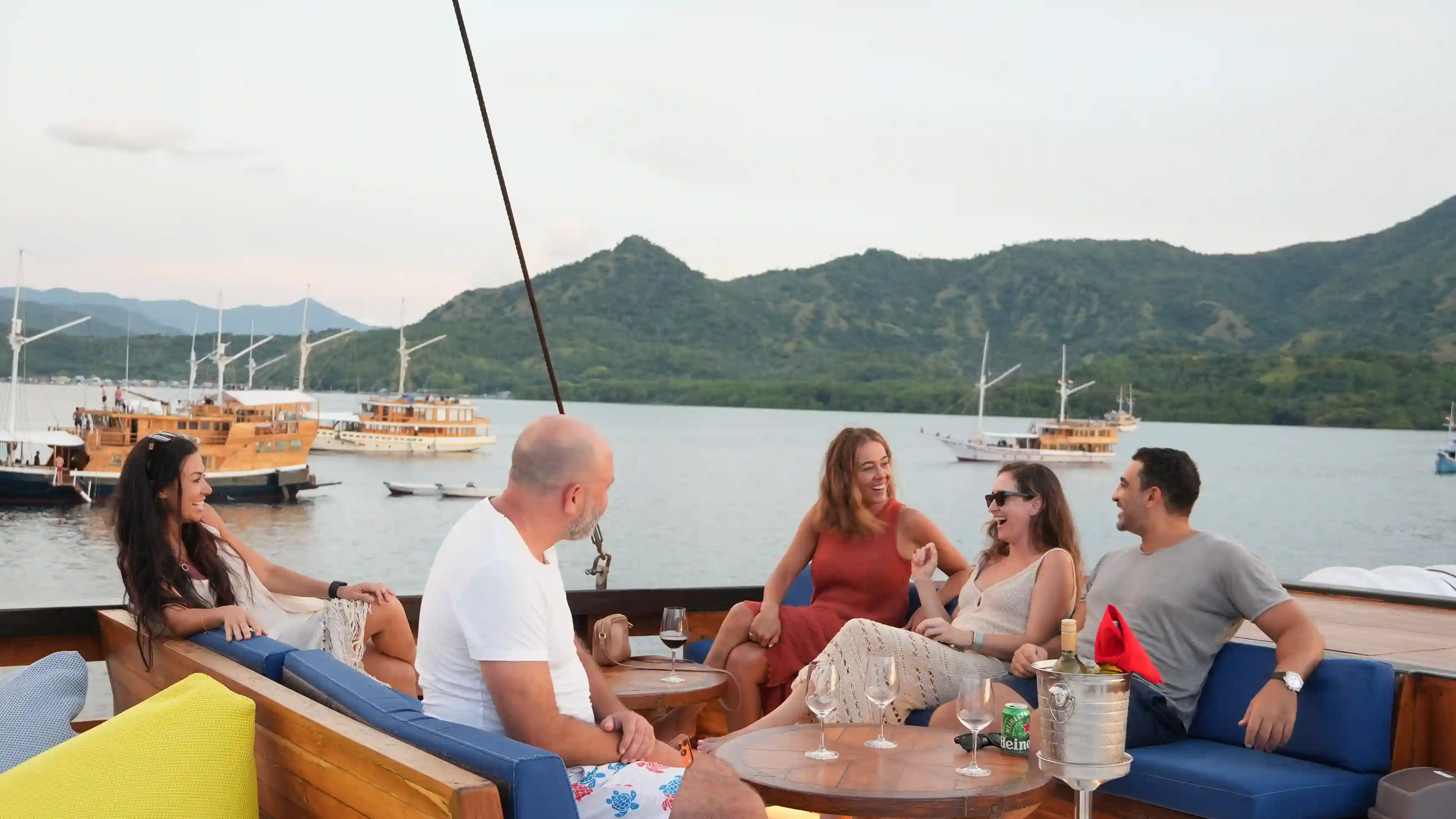 A group relaxing together on deck at sunset