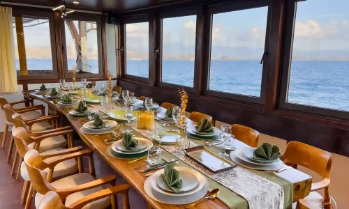 The air-conditioned indoor dining area on Neptune Cruise Phinisi