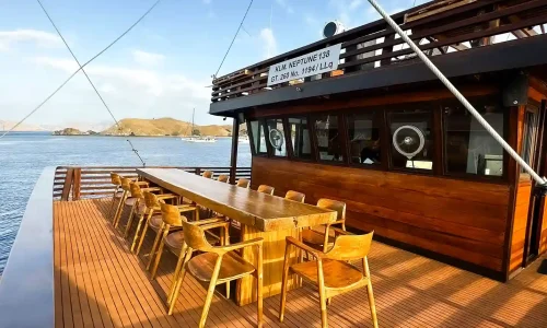 Shaded outdoor seating on the main deck of Neptune Cruise Phinisi